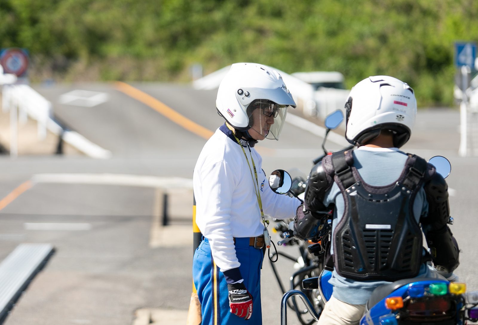 ヘルメット姿の指導員と教習生